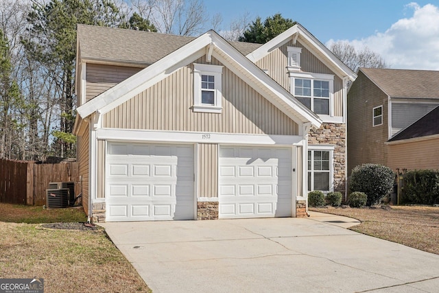 view of front of property featuring a garage and cooling unit