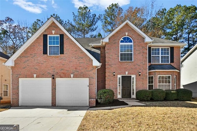 view of property featuring a garage and a front lawn