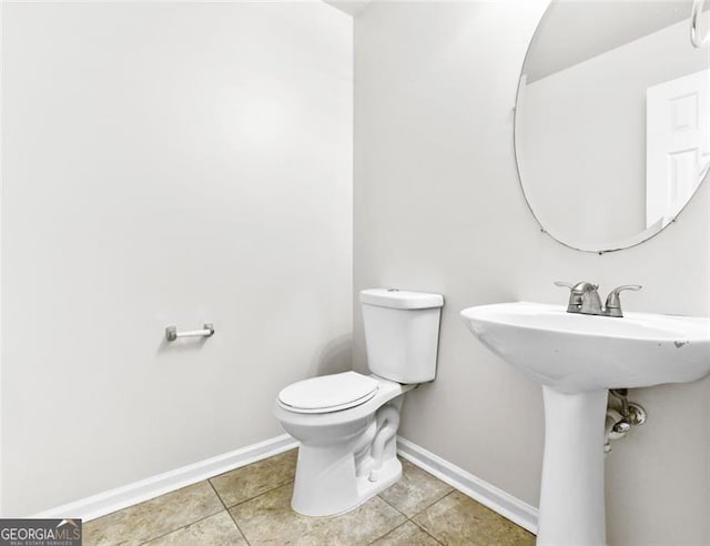 bathroom with toilet and tile patterned floors