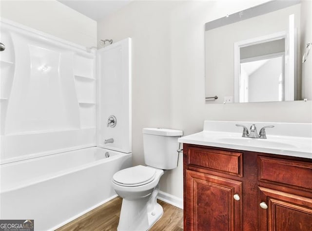 full bathroom with vanity, toilet, hardwood / wood-style floors, and shower / tub combination