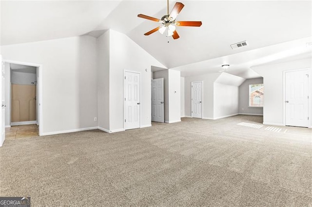 unfurnished living room featuring vaulted ceiling, carpet flooring, and ceiling fan