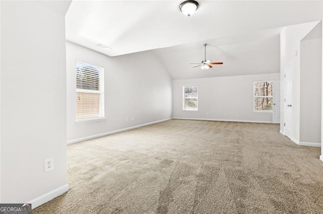 unfurnished living room with vaulted ceiling, ceiling fan, and carpet floors