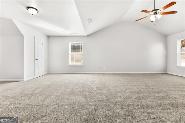 additional living space with ceiling fan, a healthy amount of sunlight, carpet floors, and lofted ceiling