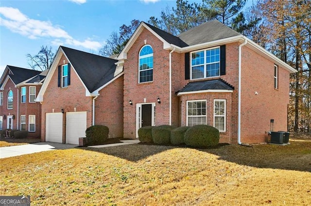 front of property with a garage, central AC, and a front lawn