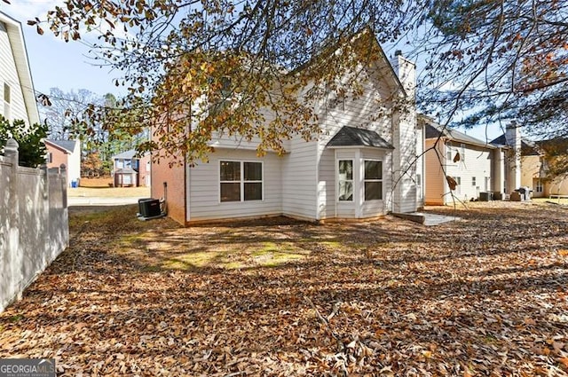 back of house with central AC unit