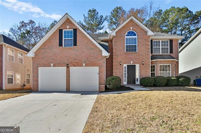 view of property featuring a garage and a front yard