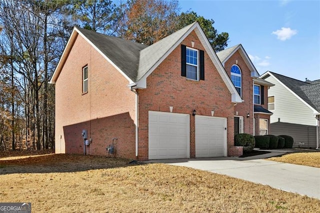 view of front of property featuring a garage and a front lawn