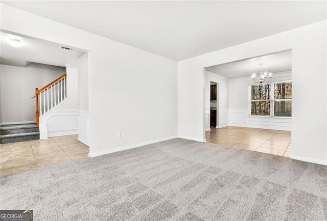 unfurnished living room with light tile patterned floors and a chandelier