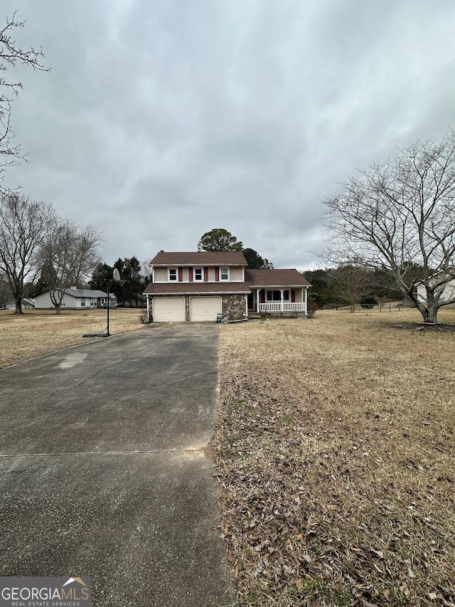 view of front of property with a porch and a garage