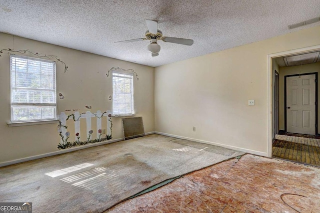 empty room featuring ceiling fan, carpet, and a textured ceiling