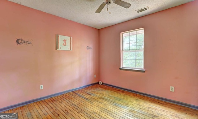 spare room with light wood-type flooring, a textured ceiling, and ceiling fan