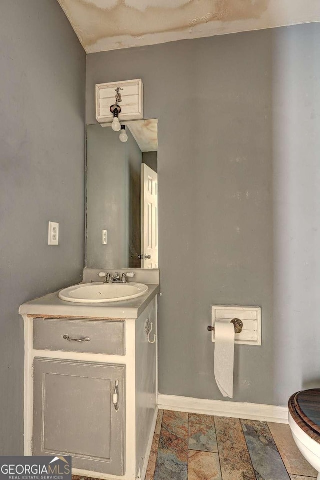 bathroom with toilet and vanity