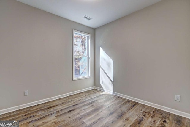 spare room featuring light wood-type flooring