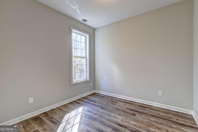 empty room with wood-type flooring