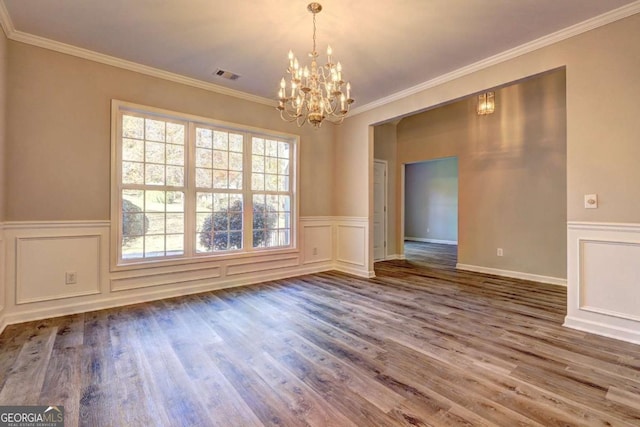 unfurnished dining area with a chandelier, ornamental molding, and wood-type flooring