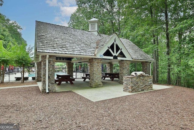 surrounding community with exterior kitchen and a gazebo