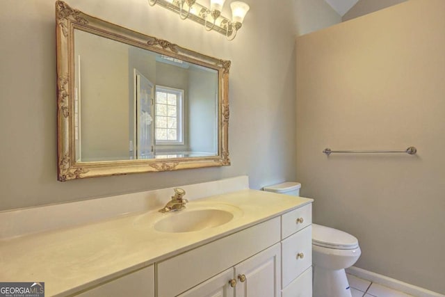 bathroom with toilet, tile patterned flooring, and vanity