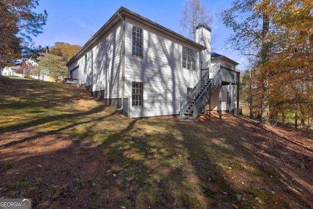 view of side of home with a yard