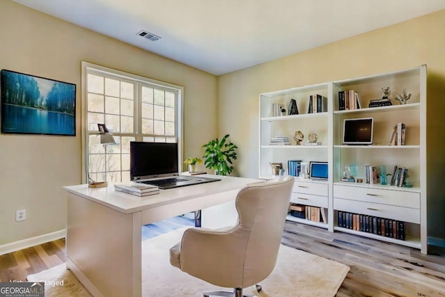 office space with light wood-type flooring