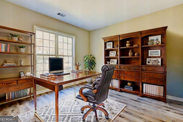 office space with light hardwood / wood-style floors