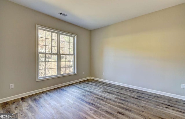 spare room with wood-type flooring