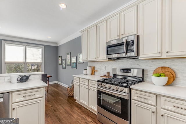 kitchen featuring baseboards, stainless steel appliances, decorative backsplash, dark wood-type flooring, and crown molding