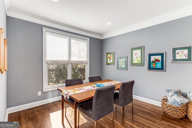 dining area featuring baseboards, wood finished floors, and ornamental molding