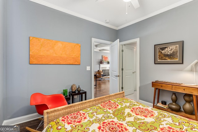 bedroom with baseboards, wood finished floors, and ornamental molding