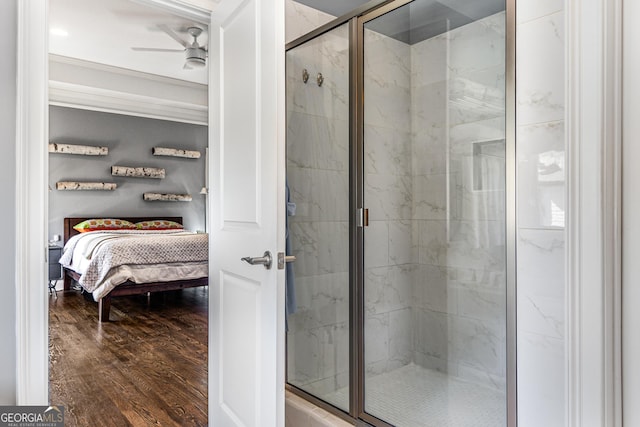 ensuite bathroom featuring ceiling fan, a marble finish shower, ensuite bath, and wood finished floors