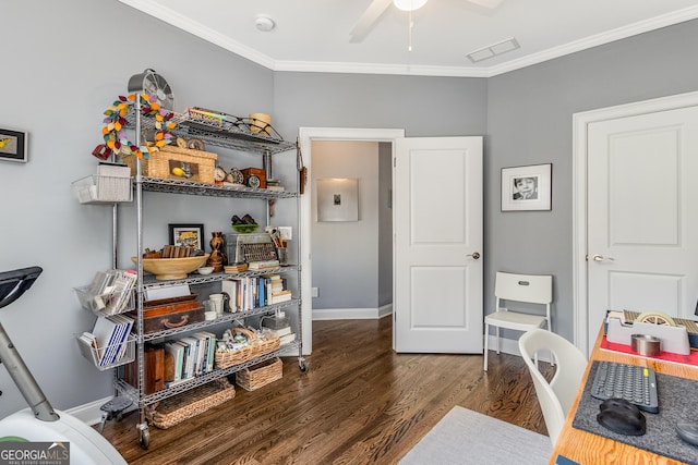 office space with a ceiling fan, wood finished floors, visible vents, baseboards, and crown molding