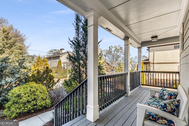 wooden terrace featuring a porch