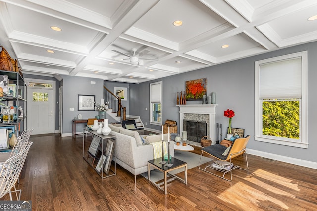 living room featuring beam ceiling, stairway, and a healthy amount of sunlight