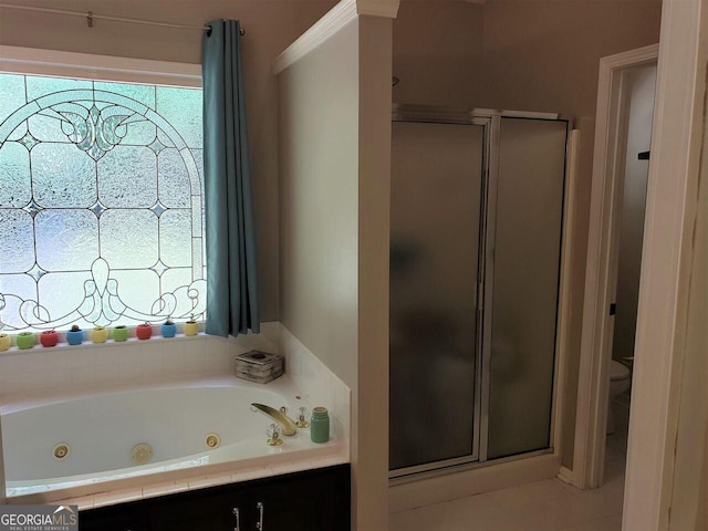 bathroom featuring tile patterned floors, a wealth of natural light, toilet, and shower with separate bathtub