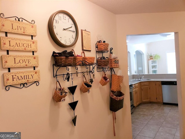 hall featuring sink and a textured ceiling