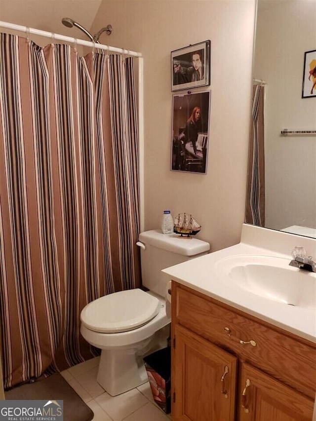 bathroom featuring toilet, tile patterned floors, and vanity