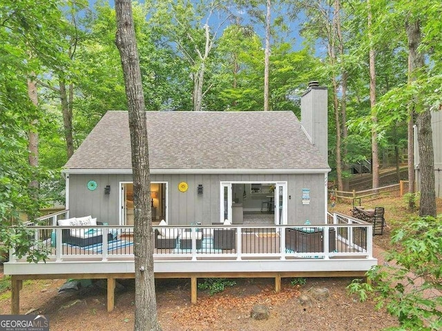 rear view of property with a wooden deck