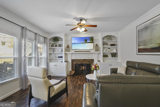 living room with built in shelves, a fireplace, and a wealth of natural light