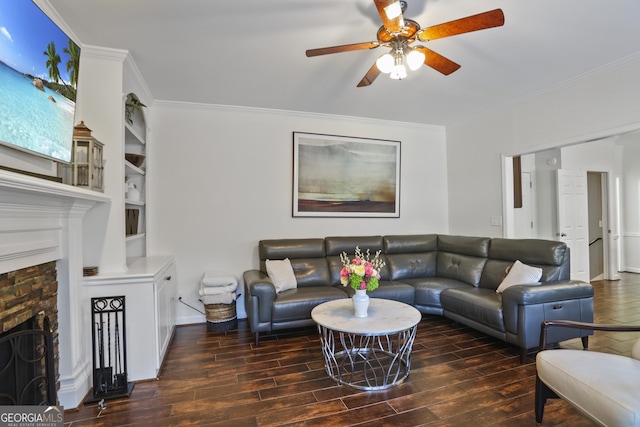 living room featuring crown molding, ceiling fan, and a brick fireplace