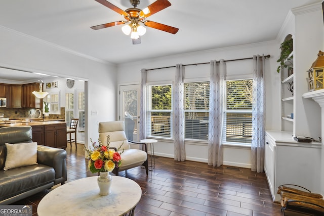 living room with ceiling fan, ornamental molding, and a healthy amount of sunlight