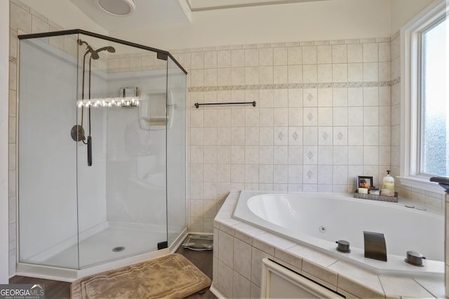 bathroom with wood-type flooring and independent shower and bath