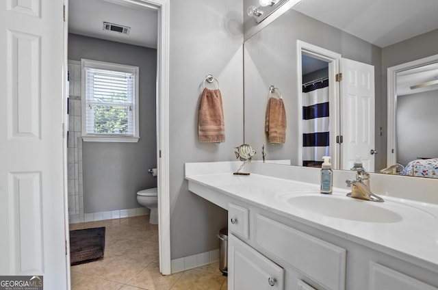 bathroom with vanity, tile patterned floors, and toilet