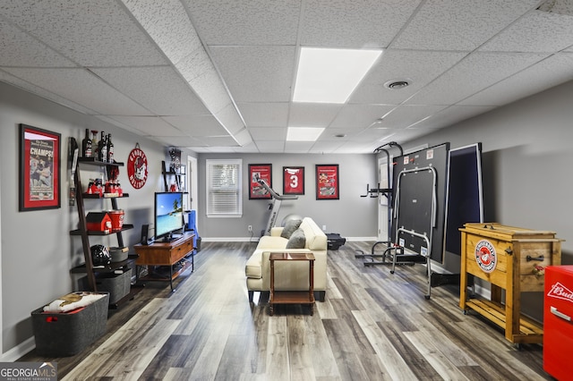 playroom with a paneled ceiling and hardwood / wood-style floors