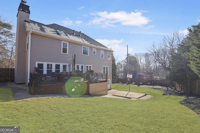 rear view of house with a yard and a patio