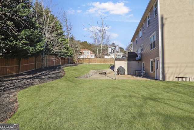 view of yard featuring central AC unit and a patio area