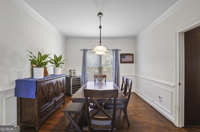 dining area with ornamental molding and dark hardwood / wood-style floors