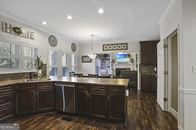 kitchen featuring crown molding, sink, backsplash, and stainless steel dishwasher