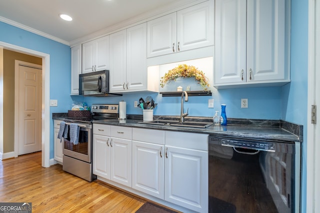 kitchen featuring sink, white cabinets, black appliances, and crown molding