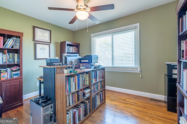 office space featuring ceiling fan and light hardwood / wood-style flooring