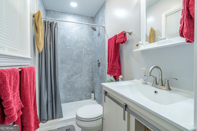 bathroom with vanity, toilet, and curtained shower