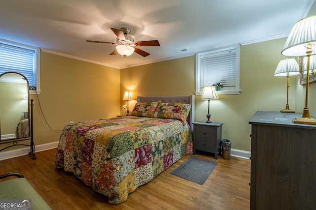 bedroom with ceiling fan, wood-type flooring, and ornamental molding